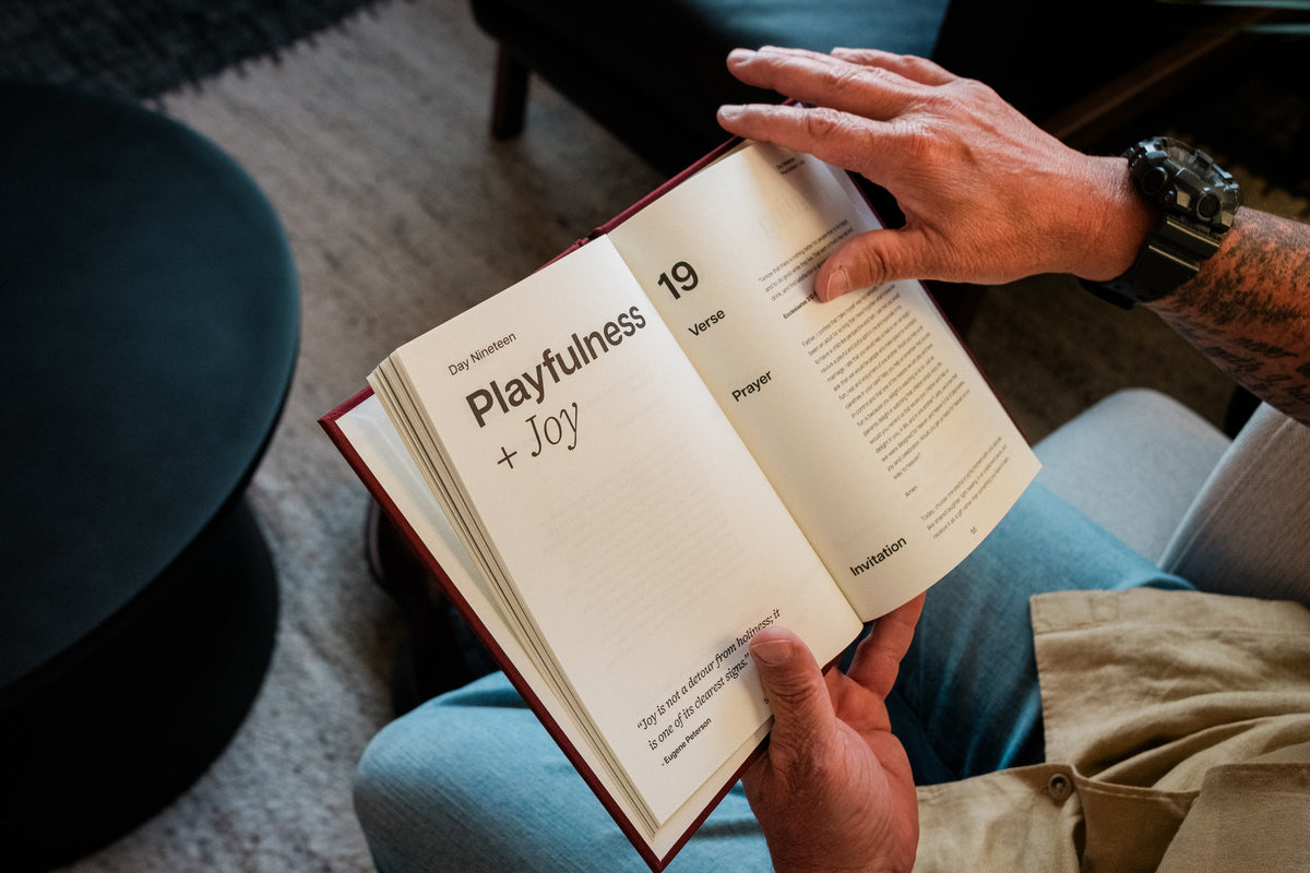 Open pages of the marriage devotional showing the Playfulness and Joy day