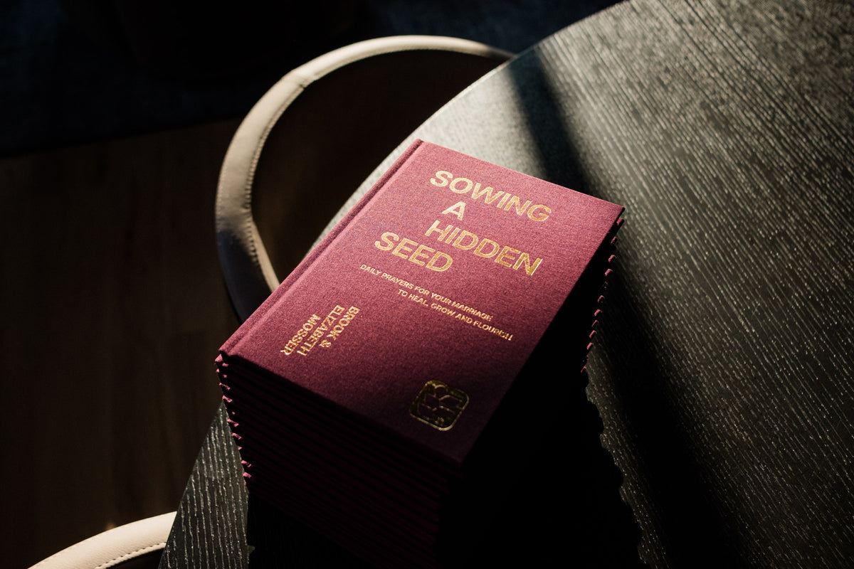 The marriage devotional resting on a chair in low light
