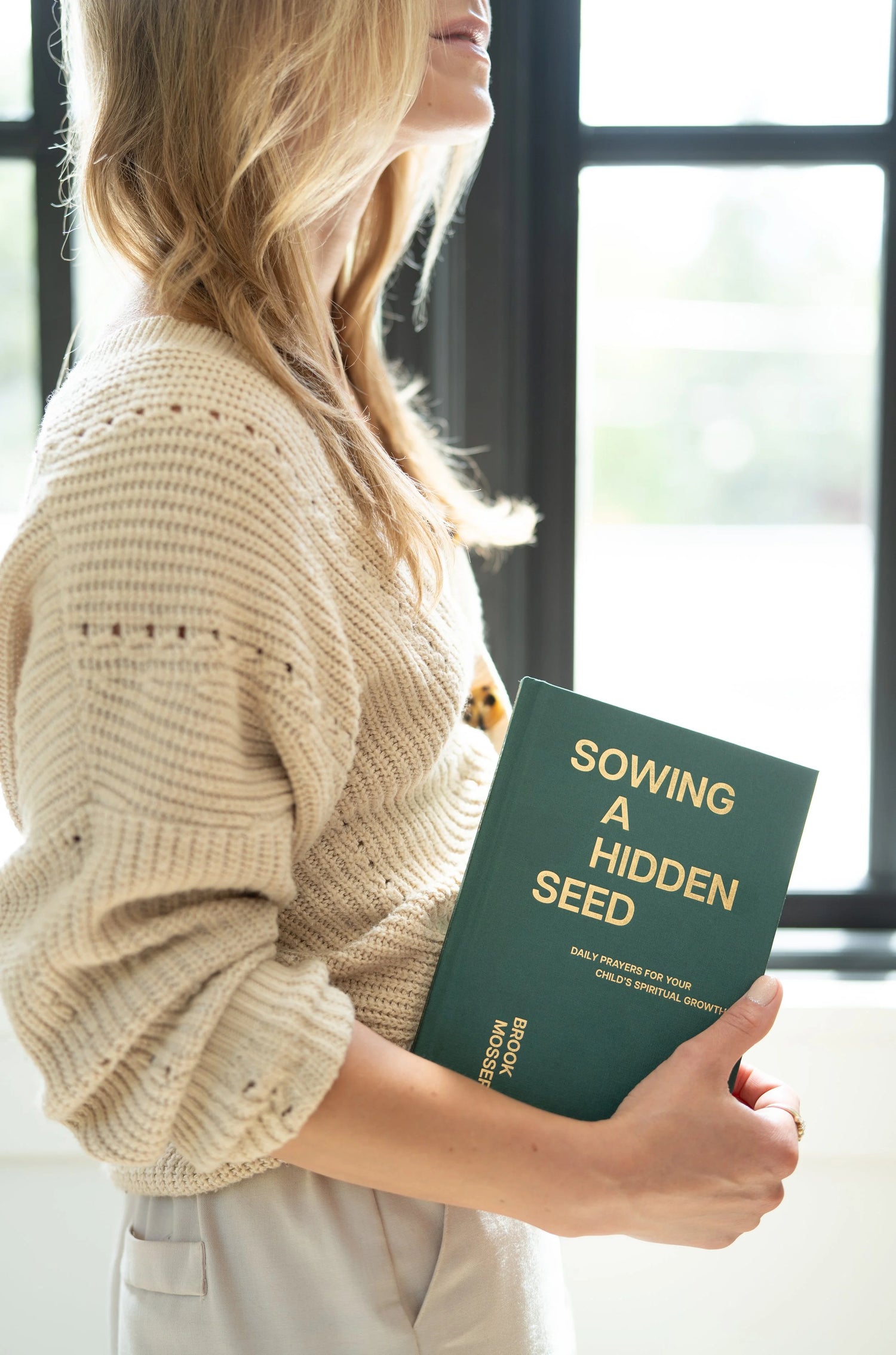 Reader holding the Sowing a Hidden Seed devotional